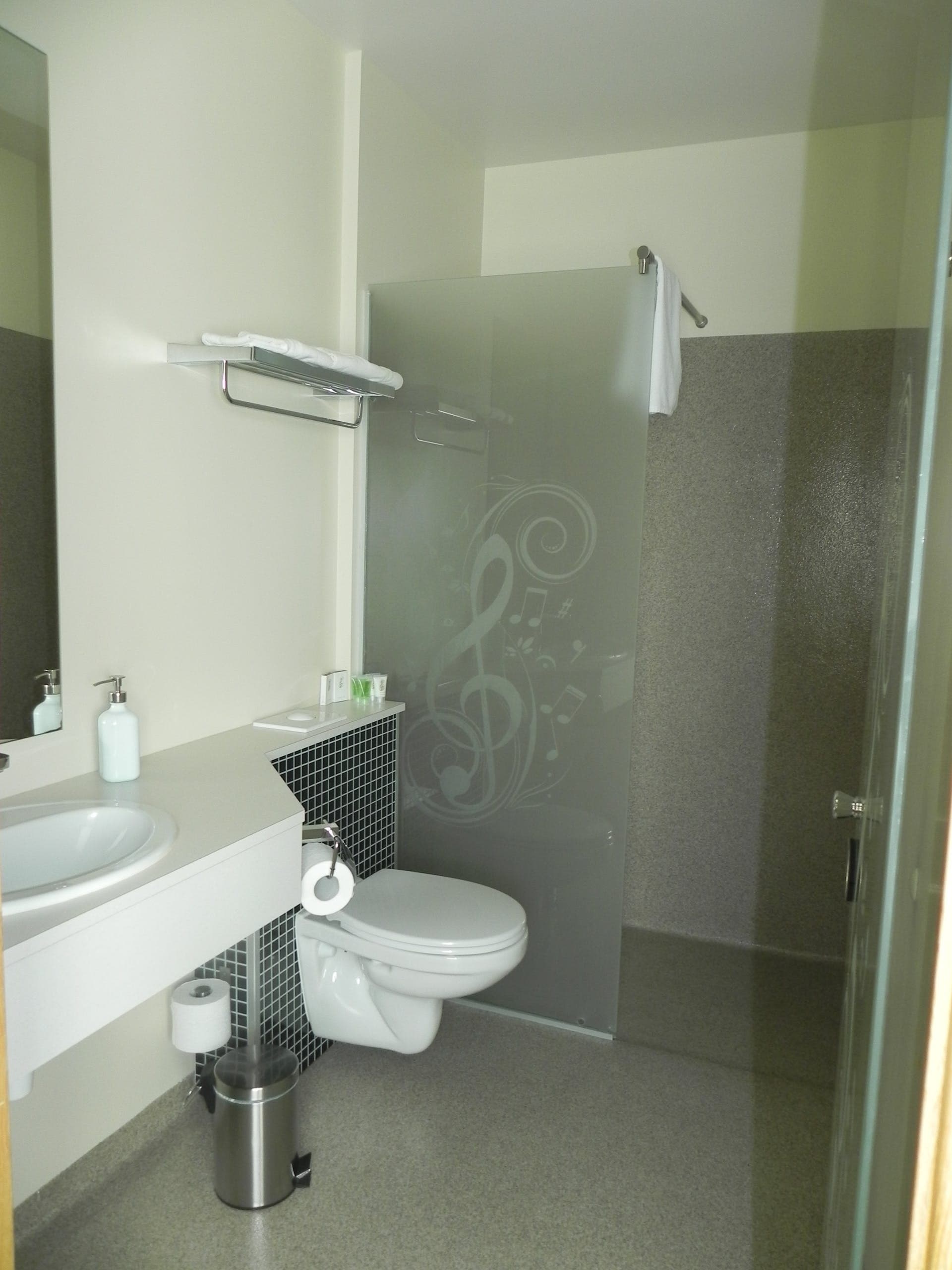 Bathroom with a shower behind a frosted glass screen