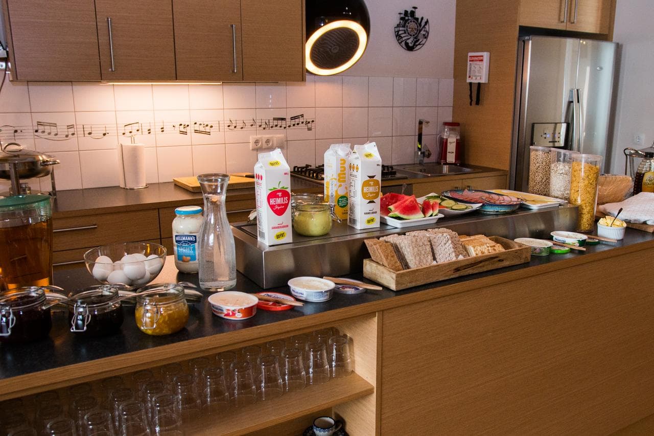 Self service breakfast of bread, cereal, eggs, juice and spreads on the counter