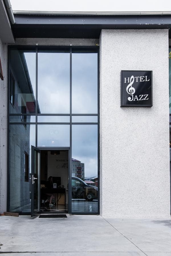 Glass entrance beside the Hotel Jazz sign